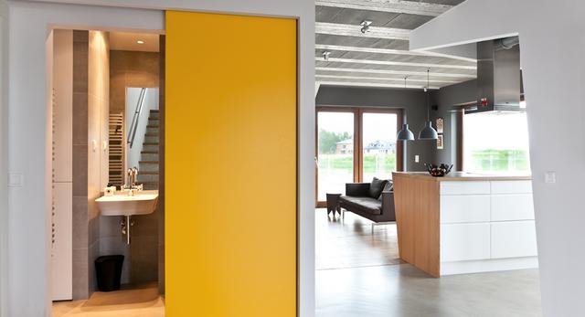 Architektura wnętrza domu w Poznaniu projektu mode:lina. Piękne wnętrza z betonu i drewna ocieplone żółtym kolorem 